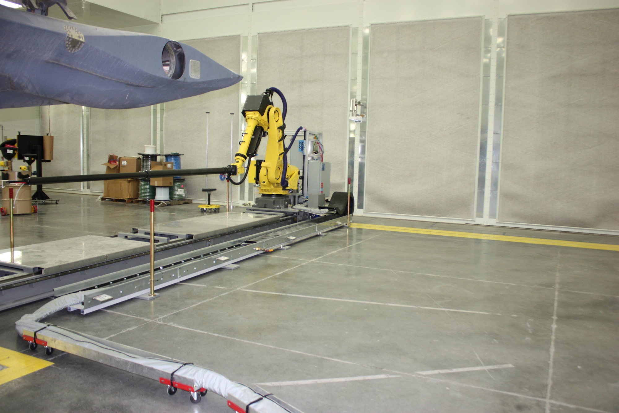An aft robot moves forward and aft on a rail to coat the aft section of an F-22 engine inlet at Hill AFB, Utah. (U.S. Air Force/Courtesy photo)