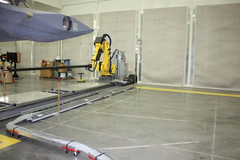An aft robot moves forward and aft on a rail to coat the aft section of an F-22 engine inlet at Hill AFB, Utah. (U.S. Air Force/Courtesy photo)