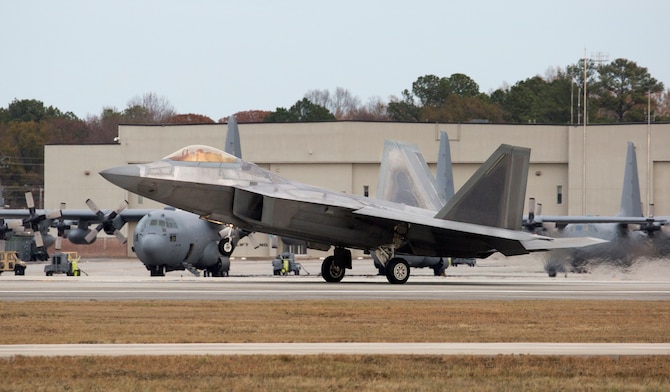 F-22 Raptors such as this one will at some point in their operational lifetime now encounter robotic technology newly developed through the Air Force Small Business Research program. Robots are now being placed into operation at the Ogden Air Logistics Complex at Hill AFB, Utah for the purpose of making the process of restoring specialized coatings on F-22 Raptor engine inlets much safer for aircraft maintenance personnel. (Courtesy photo/Andrew McMurtrie, Lockheed Martin Aeronautics Company, Marietta, Ga.)