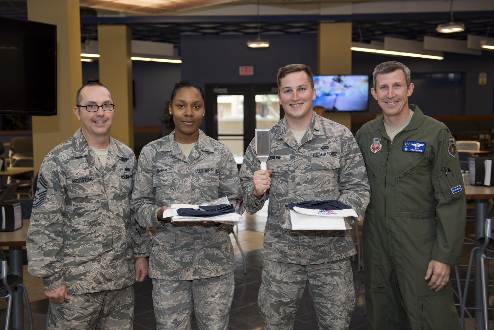 Col. Thomas Kunkel, right, 23d Wing commander, and Chief Master Sgt. Jarrod Sebastian, left, 23d Wing command chief, pose with the winners of the first Iron Chef Competition, Senior Airman Shakilah Bates, 23d Force Support Squadron food service specialist, and 1st Lt. James Ogilvie, 23d FSS Sustainment Services flight commander, who’s meal included a “Surfs up,” burger consisting of pineapple, barbeque sauce and a blend of spices, March 23, 2017, at Moody Air Force Base, Ga. Four teams were given an hour to prepare their meals for the judges. The 23d Force Support Squadron plans to hold at least one Iron Chef Competition per year. (U.S. Air Force photo by Airman 1st Class Daniel Snider)