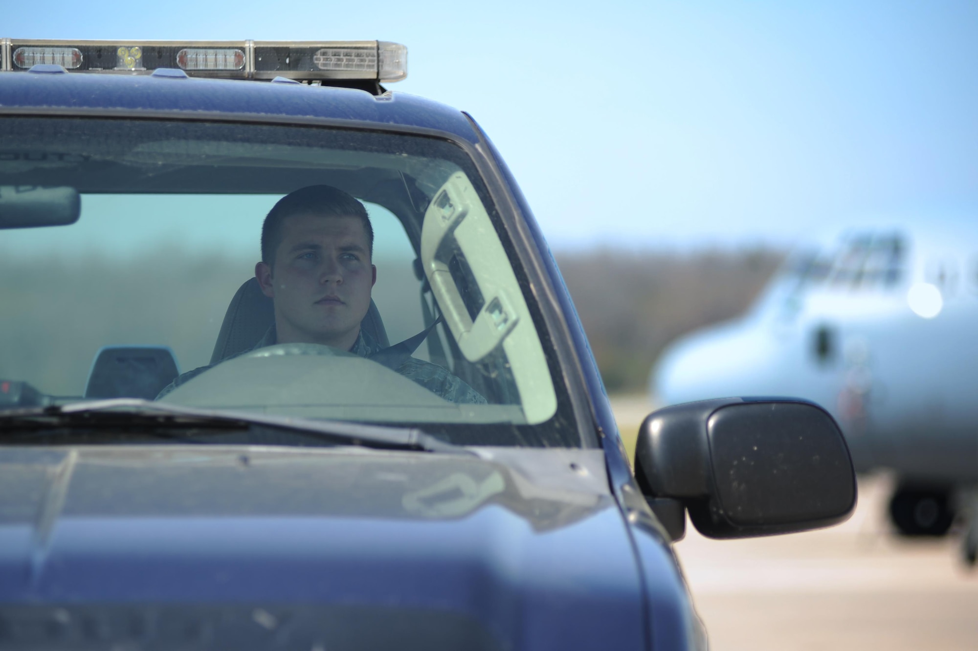 U.S. Air Force Senior Airman Joseph Way, 19th Operations Support Squadron Airfield Management shift lead, looks for safety hazards March 20, 2017, on the flightline at Little Rock Air Force Base, Ark. The airfield management team conducts airfield checks every two hours, looking for problems from potholes to foreign objects and debris. (U.S. Air Force photo by Airman 1st Class Grace Nichols)