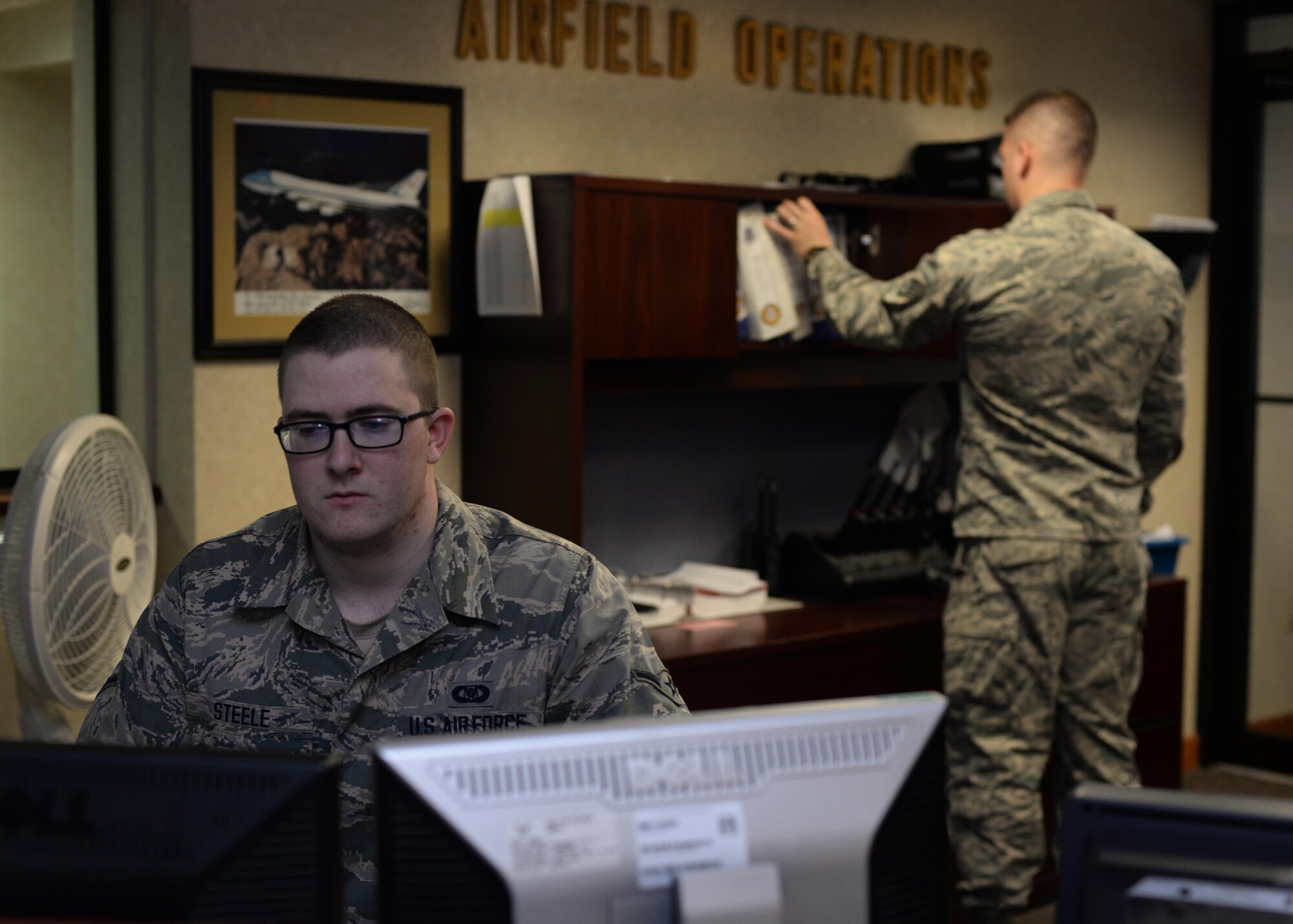 U.S. Air Force Airman Ian Steele, 19th Operations Support Squadron Airfield Management shift lead, mans the customer service desk March 20, 2017, at the airfield management shop on Little Rock Air Force Base, Ark. Members of the 19th Operations Support Squadron Airfield Management team work around the clock to provide a safe, efficient and effective airfield environment for all aircraft operations. (U.S. Air Force photo by Airman 1st Class Grace Nichols)