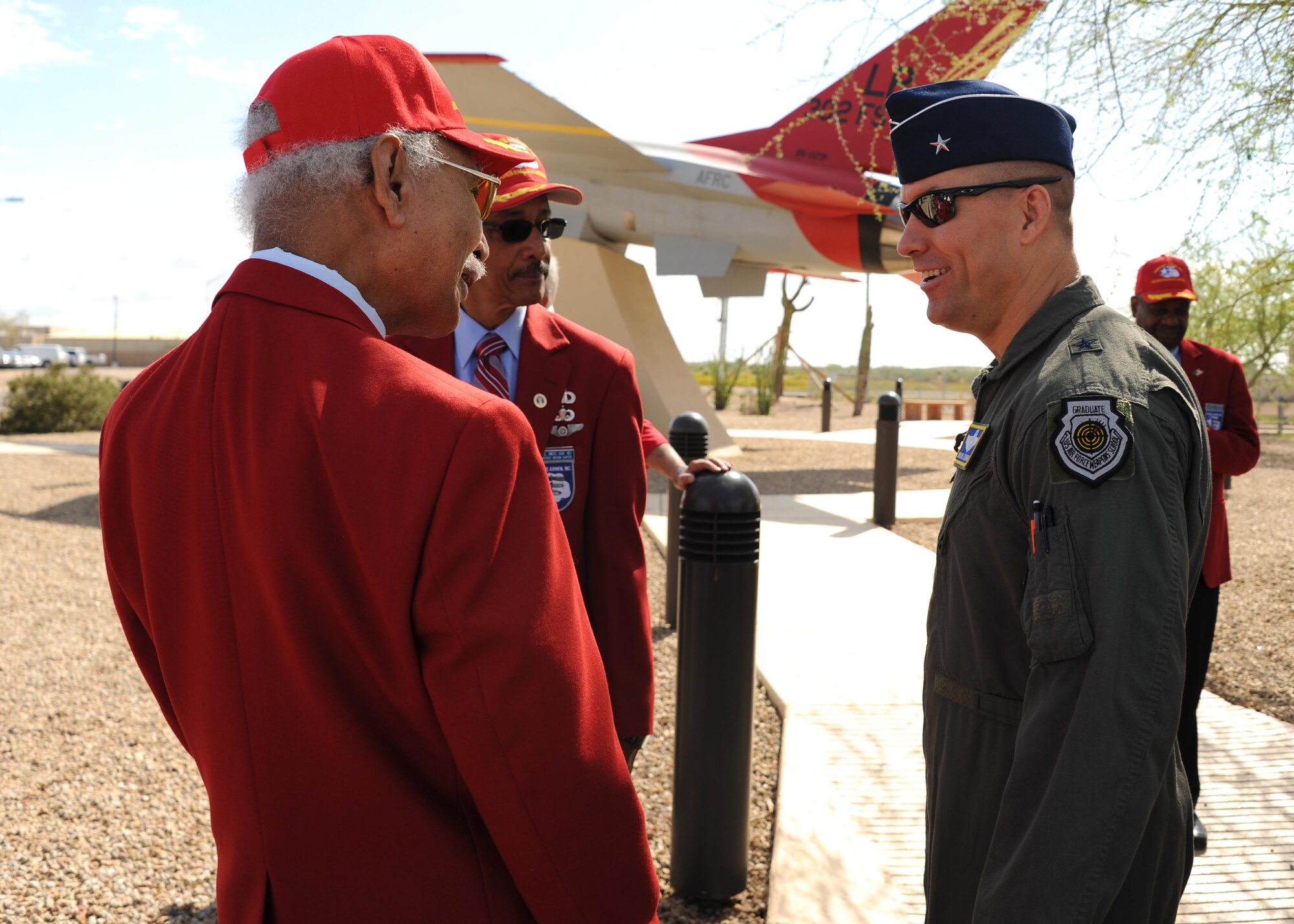 Brig. Gen. Brook Leonard, 56th Fighter Wing Commander, interacts with members of the Archer-Ragsdale Chapter of Tuskegee Airmen March 23, 2017, at Luke Air Force Base, Ariz. Luke’s relationship with the Tuskegee Airmen stems through the 302nd Fighter Squadron which was one of four African-American fighter squadrons to enter combat during World War II. The 302nd FS was attached to the 944th Fighter Wing Reserve Component which calls Luke home today. (U.S. Air Force photo by Airman 1st Class Caleb Worpel)