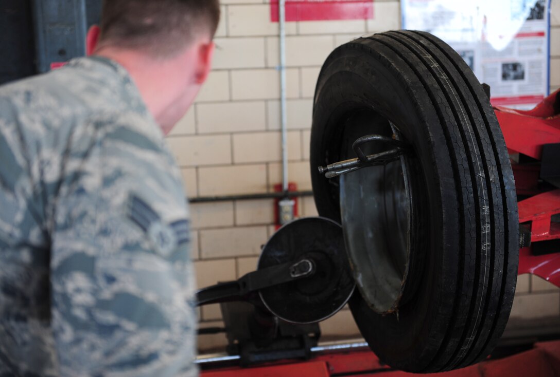 U.S. Air Force Senior Airman Ethan Blanton, 7th Logistics Readiness Squadron vehicle mechanic, operates a tire remover machine as he watches the tire and rim separate at Dyess Air Force Base, Texas, March 21, 2017. The tire remover machine is used to separate the tire from the rim and to install a new tire on the rim. (U.S. Air Force photo by Airman 1st Class April Lancto)