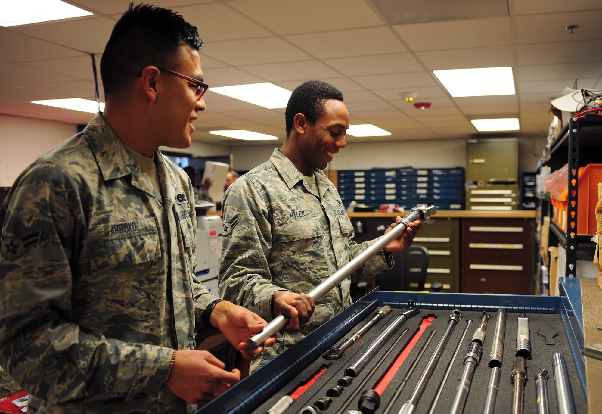 U.S. Air Force Airman 1st Class Jorge Arroyo, 7th Logistics Readiness Squadron vehicle mechanic, left, receives guidance on tool management and accountability from fellow LRS vehicle mechanic Airman 1st Class Isaiah Hyler, right, at Dyess Air Force Base, Texas, March 23, 2017. Each vehicle mechanic has their own personally identifiable chip, which is swapped for a tool the mechanic needs for accountability purposes. (U.S. Air Force photo by Airman 1st Class April Lancto)