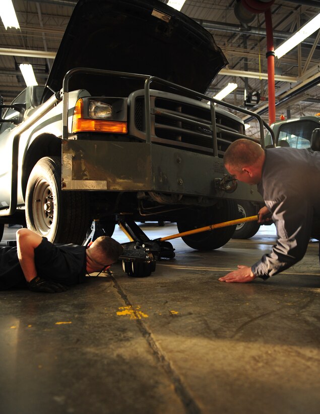 U.S. Air Force Senior Airman Bradley Hall, left, watches Senior Airman Tyler Bryant, right, both 7th Logistics Readiness Squadron vehicle mechanics, lift a vehicle at Dyess Air Force Base, Texas, Jan. 5, 2017. Airmen assigned to vehicle maintenance fix different vehicles across the base. (U.S. Air Force photo by Airman 1st Class April Lancto)