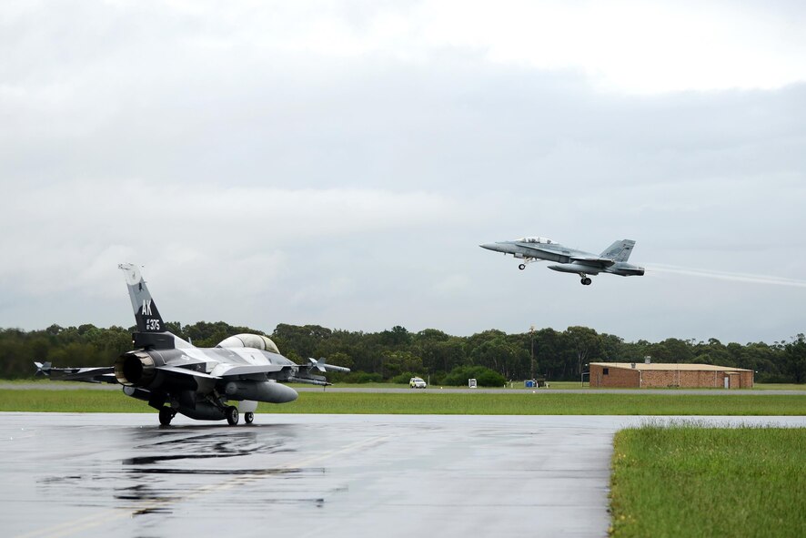 U.S. Air Force Maj. Shawn McGoffin, 354 Fighter Wing deputy inspector general and F-16 pilot, and U.S. Air Force Tech. Sgt. Wesley Walker, a 354th Maintenance Squadron aircraft munitions systems specialist, taxi in an F-16 Fighting Falcon as a Royal Australian Air Force F-18 Hornet taxes off at RAAF Base Williamtown, in New South Wales, Australia, March 24, 2017. Prior to the 18th Aggressor Squadron completing their final sortie in Exercise Diamond Shield, Walker was offered an opportunity to observe the mission of training and preparing Royal Australian Air Force fighter combat instructors, airspace battle managers, fighter intelligence instructors and fighter combat controllers of the RAAF Air Warfare Centre Instructors Course from a perspective he’s never seen before; from 30,000 feet in the air. (U.S. Air Force photo by Tech. Sgt. Steven R. Doty)