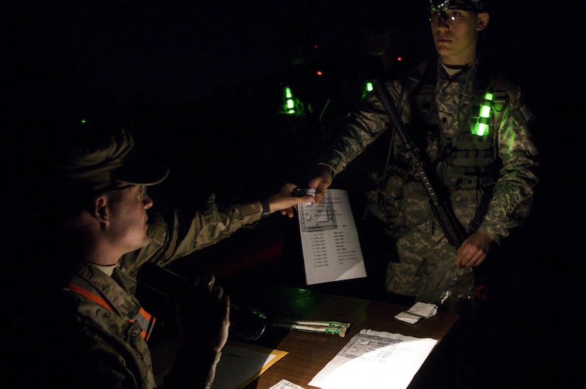 With only the moon light, red flash lights and glow sticks Soldiers from across the command put their night land navigation skills to the test at this year’s 200th Military Police Command’s Best Warrior Competition held at Fort Hunter Liggett, Calif, Mar. 17. Competitors test their Army aptitude by completing warfare simulations, board interviews, physical fitness tests, written exams, and Warrior tasks and battle drills. (US Army photo by Sgt. Elizabeth Taylor)
