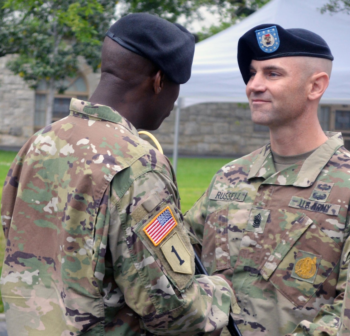 Command Sgt. Maj. Craig Russell (right) accepts the NCO sword from Col. Terance Huston (left), 5th Recruiting Brigade commander, during the brigade’s change of responsibility ceremony March 24 at the historic quadrangle on JBSA-Fort Sam Houston, signifying his acceptance of the command sergeant major position for the Brigade.  