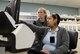 Juliette Zuber, 14th Medical Support Squadron Pharmacy, and Katie Steinback, a student in the Education Center’s pharmacy technician program, discuss day-to-day pharmacy operations March 13, 2017, at Columbus Air Force Base, Mississippi. The new equipment makes learning how to be a pharmacy technician easier due to the user-friendly applications. (U.S. Air Force photo illustration by Airman 1st Class Beaux Hebert)