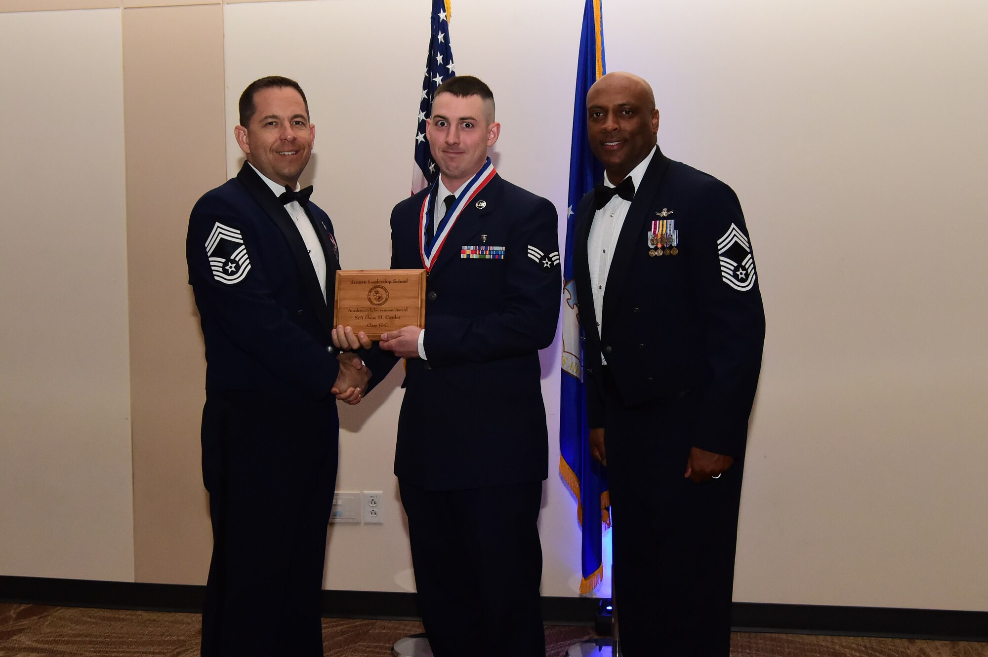 Senior Airman Dane Carder accepts the academic award during an Airman Leadership School graduation March 23, 2017, at the Leadership Development Center on Buckley Air Force Base, Colo. This award represents Airmen who received the highest grade in their class. (U.S. Air Force photo by Airman 1st Class Jessica Huggins/Released)