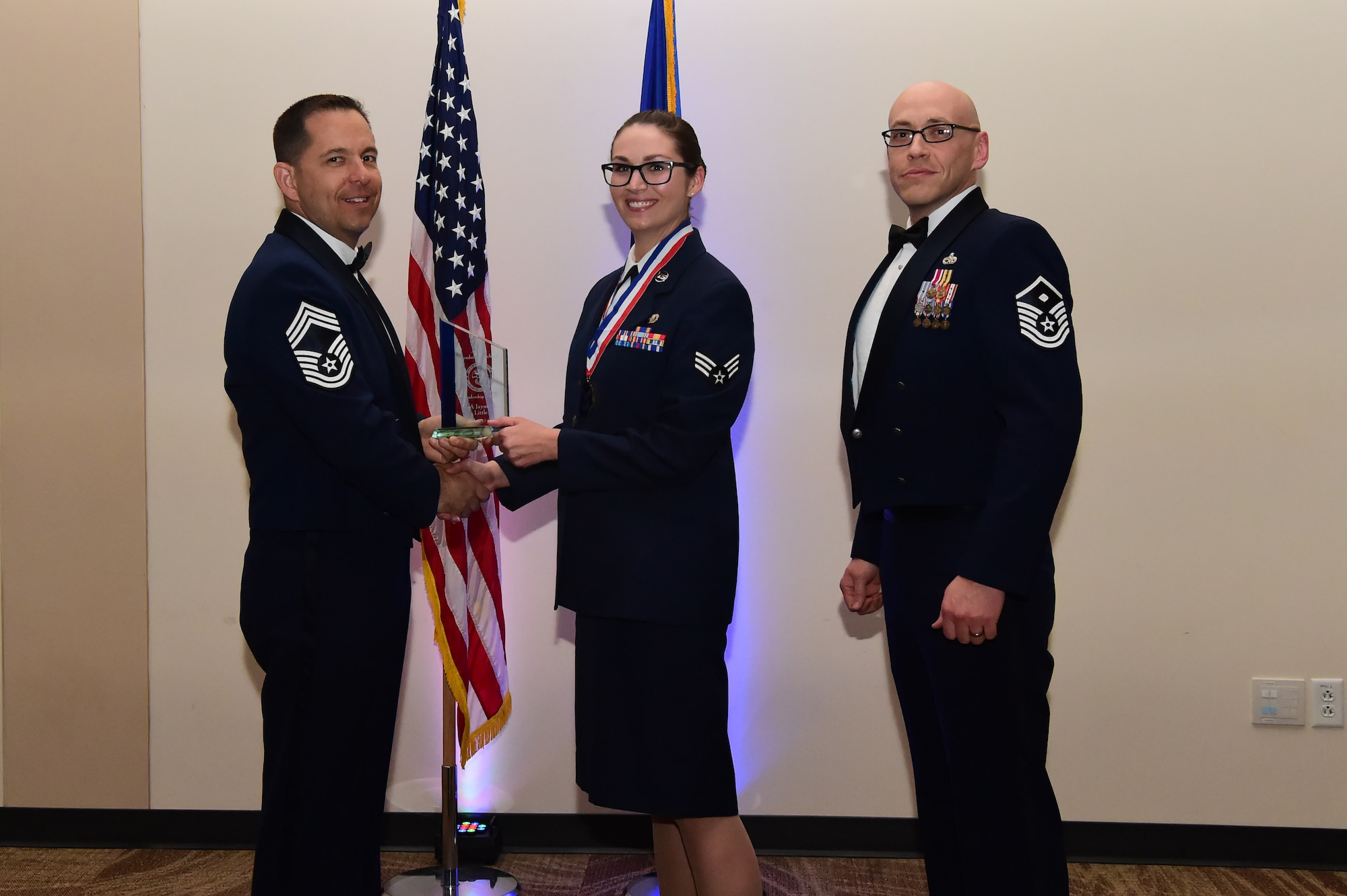Senior Airman Jayme Little accepts the leadership award during an Airman Leadership School graduation March 23, 2017, at the Leadership Development Center on Buckley Air Force Base, Colo. This award represents Airmen who exhibited exemplary leadership skills within their class. (U.S. Air Force photo by Airman 1st Class Jessica Huggins/Released)