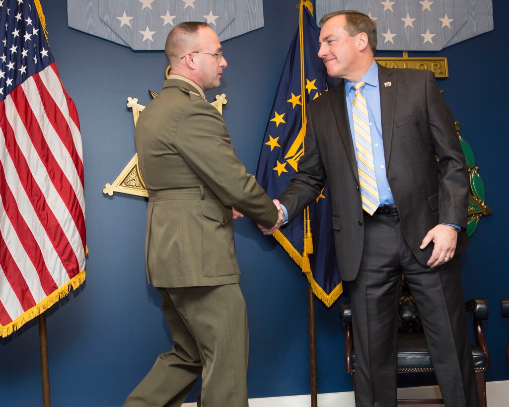 U.S. Marine Corps Col. Paul R. Weaver, commanding officer of Marine Air Control Group 48, 4th Marine Aircraft Wing, Marine Forces Reserve, shakes hands with U.S. Air Force ret. Col. Dan Merry, during the 2016 Reserve Family Readiness Award ceremony at the Hall of Heroes in the Pentagon, Arlington, Va., March 24, 2017. The Family Readiness Award recognizes the National Guard and Reserve Units with the best programs to support their military families. (U.S. Marine Corps photo by Lance Cpl. Paul A. Ochoa) 