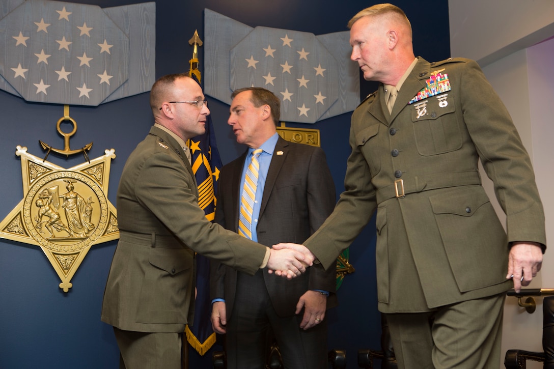U.S. Marine Corps Col. Paul R. Weaver, commanding officer of Marine Air Control Group 48, 4th Marine Aircraft Wing, Marine Forces Reserve, shakes hands with U.S. Marine Corps Brig. Gen. Bradley S. James, commanding general of 4th Marine Aircraft Wing, during the 2016 Reserve Family Readiness Award ceremony at the Hall of Heroes in the Pentagon, Arlington, Va., March 24, 2017. The Family Readiness Award recognizes the National Guard and Reserve Units with the best programs to support their military families. (U.S. Marine Corps photo by Lance Cpl. Paul A. Ochoa)
