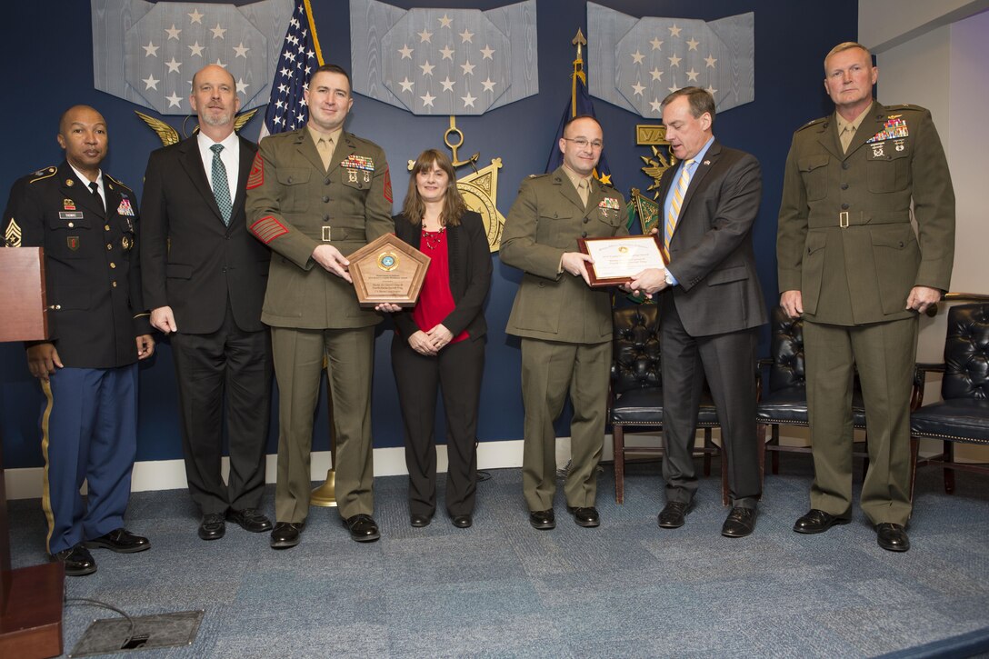 Members of the Department of Defense and Marines with the Marine Air Control Group 48, 4th Marine Aircraft Wing, Marine Forces Reserve, pose for a photo at the 2016 Reserve Family Readiness Award ceremony at the Hall of Heroes in the Pentagon, Arlington, Va., March 24, 2017. The Family Readiness Award recognizes the National Guard and Reserve Units with the best programs to support their military families. (U.S. Marine Corps photo by Lance Cpl. Paul A. Ochoa)