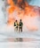 Two airmen from the Mountain Home Air Force Base Fire Department practice extinguishment techniques during a live-fire exercise here, Feb. 16, 2017. Airmen at the Fire Protection Flight train for the worst during their training scenarios. (U.S. Air Force photo by Senior Airman Malissa Lott/Released)