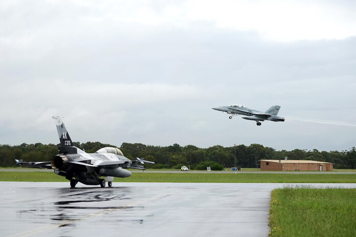 U.S. Air Force Maj. Shawn McGoffin, 354 Fighter Wing deputy inspector general and F-16 pilot, and U.S. Air Force Tech. Sgt. Wesley Walker, 354th Maintenance Squadron aircraft armament systems technician, taxi in an F-16 Fighting Falcon as a Royal Australian Air Force F-18 Hornet taxes off at RAAF Base Williamtown, in New South Wales, Australia, March 24, 2017. Prior to the 18th Aggressor Squadron completing their final sortie in Exercise Diamond Shield, Walker was offered an opportunity to observe the mission of training and preparing Royal Australian Air Force fighter combat instructors, airspace battle managers, fighter intelligence instructors and fighter combat controllers of the RAAF Air Warfare Centre Instructors Course from a perspective he’s never seen before; from 30,000 feet in the air. (U.S. Air Force photo by Tech. Sgt. Steven R. Doty)
