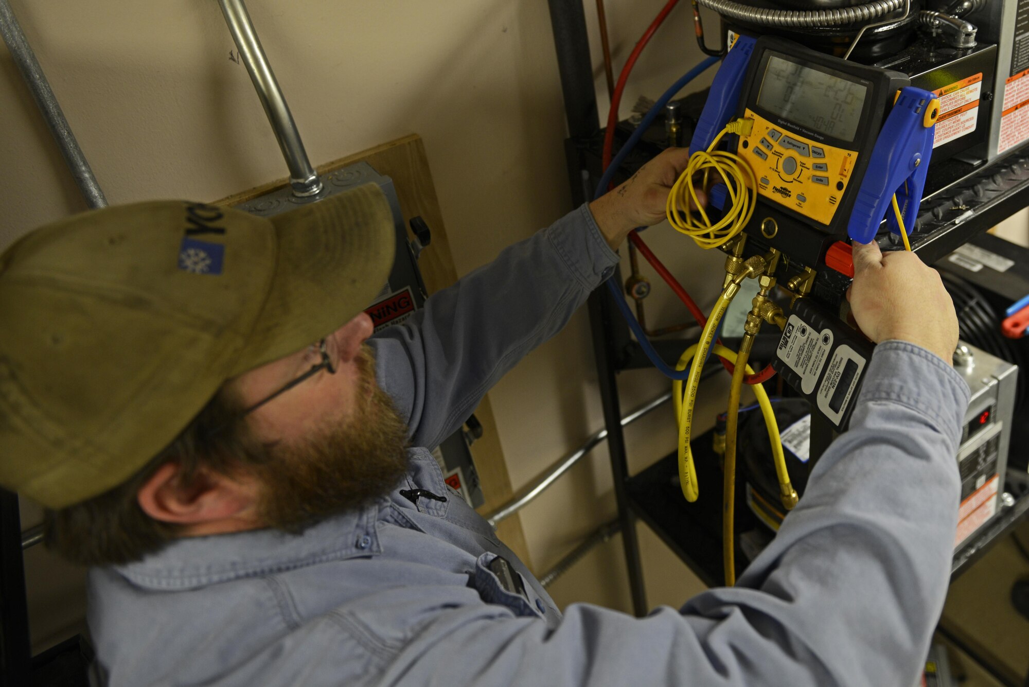 Shane Shepperd, Heating Ventilation Air Conditioning/Refrigerant technician, 773 Civil Engineering Squadron, prepares a line set for refrigerant at a restaurant on Joint Base Elmendorf-Richardson, March 22, 2017. Shepperd pumped nitrogen through the line to clear it of any debris that accumulated over time. Once the line is clear, refrigerant will be introduced to keep the freezer cooler motor from overheating. 