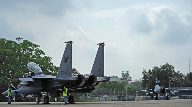 A Republic of Singapore air force F-15 (front) sits across from a U.S. Air Force F-15 after completing a training mission during exercise Cope Tiger 17 at Korat Royal Thai Air Force Base, Thailand, March 24, 2017. The annual multilateral exercise, which involves a combined total of 76 aircraft and 43 air defense assets, is aimed at improving combined combat readiness and interoperability between the Republic of Singapore air force, Royal Thai air force, and U.S. Air Force, while concurrently enhancing the three nations' military relations. (U.S. Air Force photo by Staff Sgt. Kamaile Chan)