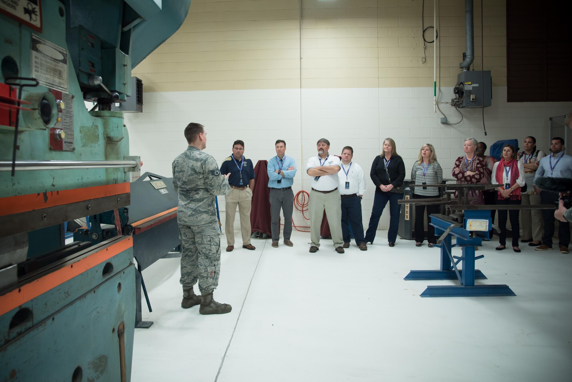 Staff Sgt. Kenan Torrance, 433rd Maintenance Squadron fabrication flight, explains tools in the sheet metal shop to Gulf Coast civic leaders during a 403rd Wing hosted civic leader tour at Joint Base San Antonio, March 23-24. (U.S. Air Force photo/Staff Sgt. Heather Heiney)