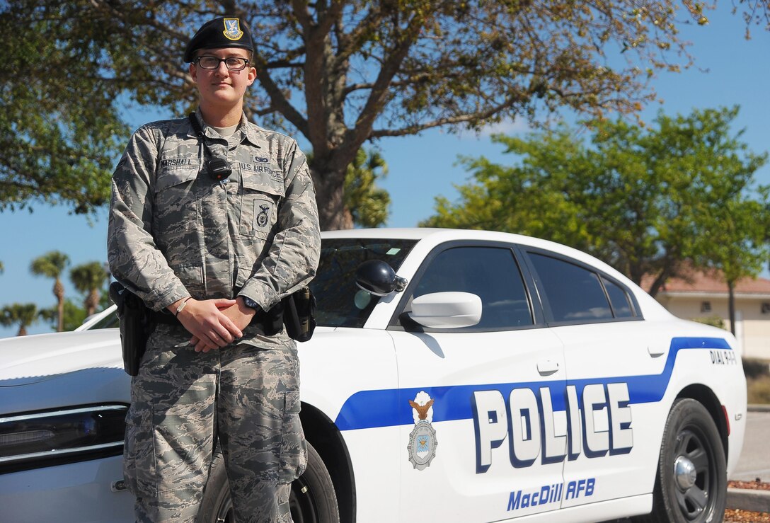 Airman 1st Class Molly Marshall, an installation patrolman assigned to the 6th Security Forces Squadron, pauses for a photo in front of her patrol car March 24, 2017 at MacDill Air Force Base, Fla. Marshall is responsible for performing routine patrols of the intersections around MacDill, to ensure all traffic laws are followed. (U.S. Air Force photo by Airman 1st Class Adam R. Shanks)