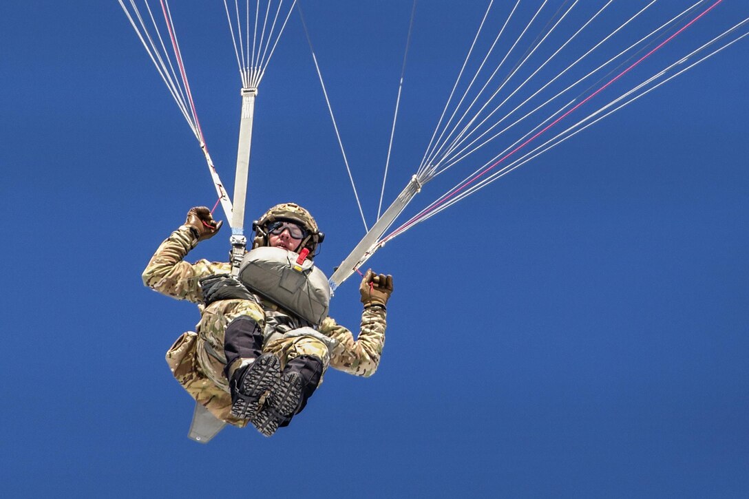 An airman descends over Malemute drop zone while conducting helicopter jump training at Joint Base Elmendorf-Richardson, Alaska, March 22, 2017. The Alaska Army National Guard’s 1st Battalion, 207th Aviation Regiment provided UH-60 Black Hawk helicopters to support the training. The airman, a tactical air control party specialist, is assigned to the 3rd Air Support Operations Squadron. Air Force photo by Alejandro Pena