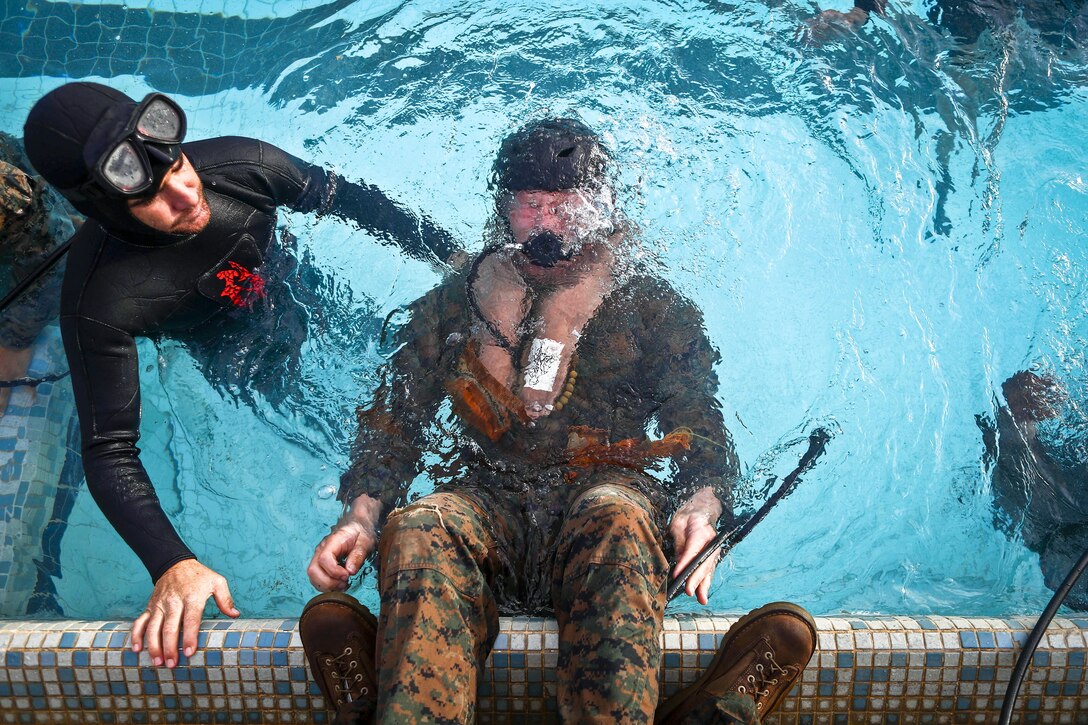 Marine Corps 2nd Lt. Brandon J. Klewicki uses an emergency breathing system during helicopter underwater egress training at the base pool at Marine Corps Base Hawaii, March 23, 2017. Marine Corps photo by Cpl. Aaron S. Patterson