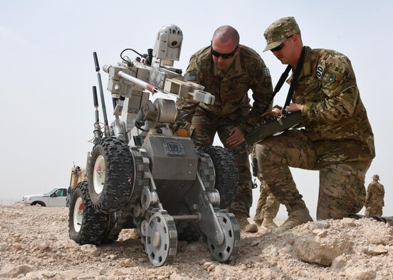 U.S. Air Force Tech. Sgt. Jeremy Pifer, left, and Staff Sgt. Brent Points, both explosive ordnance disposal technicians with the 379th Expeditionary Civil Engineer Squadron Explosive Ordnance Disposal flight, move an F6A bomb disposal robot at Al Udeid Air Base, Qatar, March 17, 2017. Both Brent and Pifer deployed from Dobbins Air Reserve Base, along with two other EOD technicians. (U.S. Air Force photo by Senior Airman Miles Wilson)