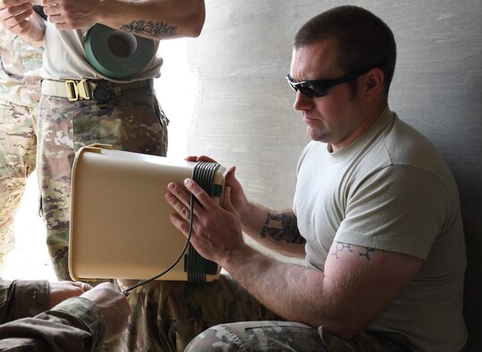 U.S. Air Force Staff Sgt. Jason Evans, an explosive ordnance disposal technician with the 379th Expeditionary Civil Engineer Squadron Explosive Ordnance Disposal Flight, wraps detonation cord around the base of a trash can at Al Udeid Air Base, Qatar, March 17, 2017. Evans, along with several other EOD technicians, created “fireball” charges, which are made by igniting a fuel mixture within the trashcans. (U.S. Air Force photo by Senior Airman Miles Wilson)