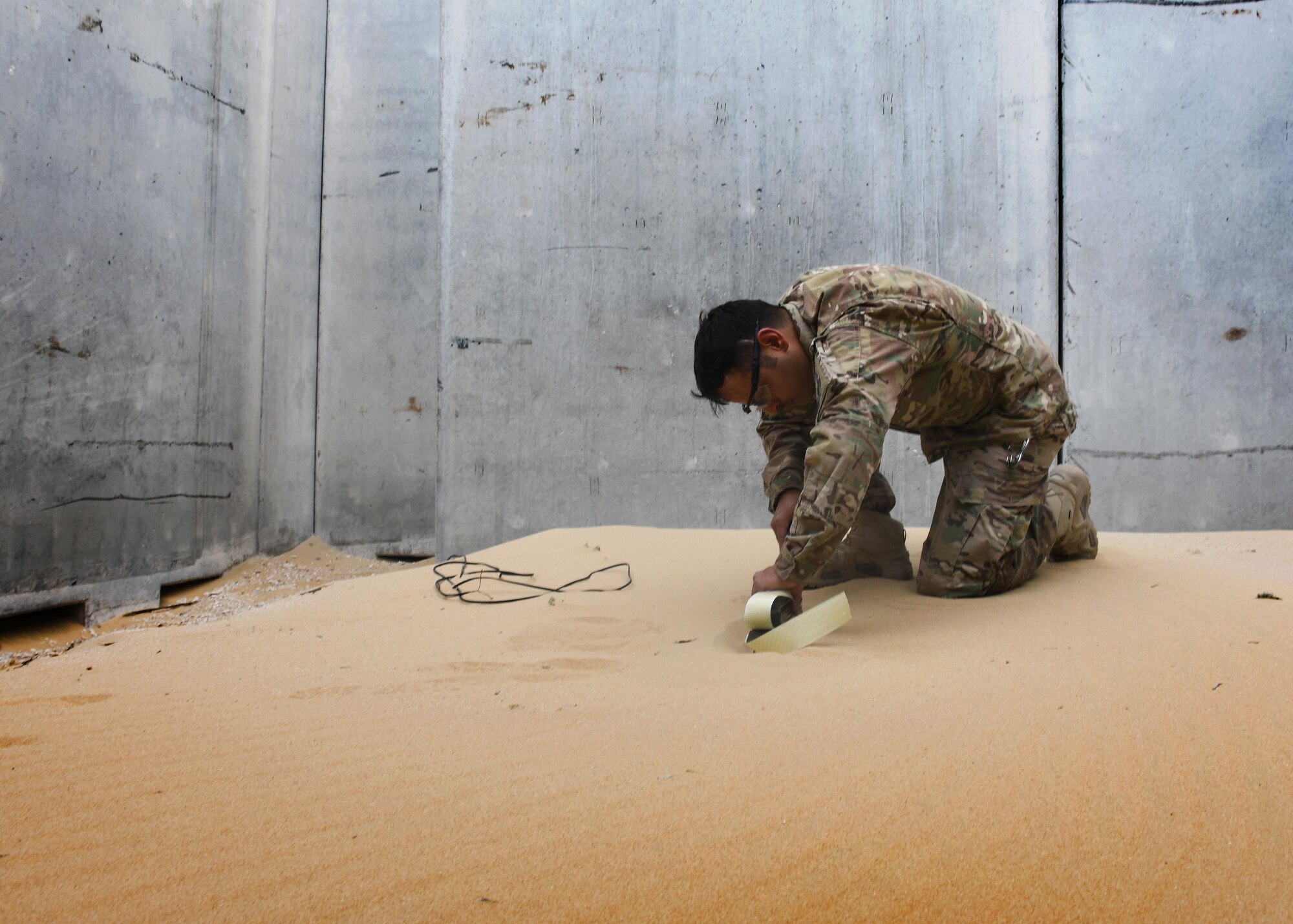 U.S. Air Force Staff Sgt. Juan Ortiz, an explosive ordnance disposal technician with the 379th Expeditionary Civil Engineer Squadron Explosive Ordnance Disposal Flight, places a C4 charge inside of the new EOD range at Al Udeid Air Base, Qatar, March 17, 2017. The new EOD range at Al Udeid allows for the EOD technicians to train with live explosives, as well as acts as an location for emergency detonations of munitions. (U.S. Air Force photo by Senior Airman Miles Wilson)