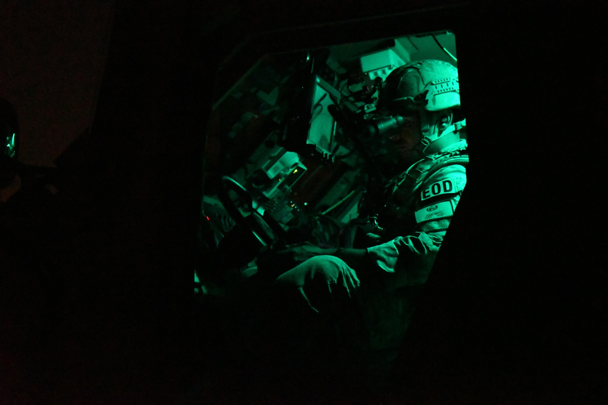 U.S. Air Force Staff Sgt. Juan Ortiz, an explosive ordnance disposal technician with the 379th Expeditionary Civil Engineer Squadron EOD flight, controls a PACBOT bomb disposal robot from inside a mine resistant ambush protected all-terrain vehicle at Al Udeid Air Base, Qatar, March 21, 2017. Ortiz was working a nighttime operations scenario during exercise “Vigilant Walrus” in order to train for bomb threats while using night vision capabilities. (U.S. Air Force photo by Senior Airman Miles Wilson)