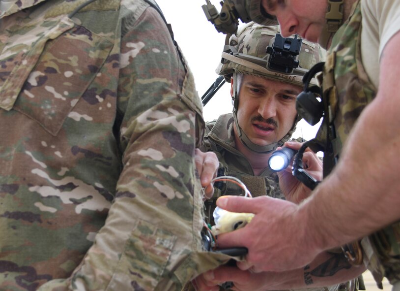 U.S. Air Force Senior Airman Andrew Vitale, and explosive ordnance disposal technician with the 379th Expeditionary Civil Engineer Squadron EOD flight, exposes an improvised explosive device attached to an Airman at Al Udeid Air Base, Qatar, March 22, 2017. During exercise “Vigilant Walrus,” Vitale worked to diffuse an IED with a hostage that had a bomb vest attached to her. (U.S. Air Force photo by Senior Airman Miles Wilson)