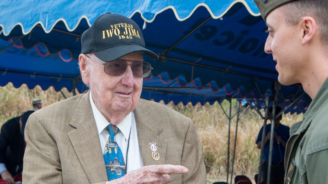 Iwo Jima veteran Fiske Hanley III talks with Marines after the wreath-laying ceremony during the 72nd Reunion of Honor commemorative service on Iwo To, Japan March 25, 2017.  Hanley was one of eight veterans in attendance alongside American and Japanese distinguished guests, both military and civilian. This event presented the opportunity for the U.S. and Japanese people to mutually remember and honor thousands of service members who fought and died on the hallowed grounds of Iwo Jima. 