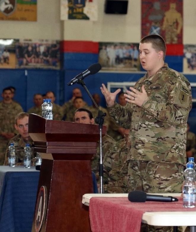 Retired Army Spc. Matt Stubblefield, formerly with D company, 1-26 Blue Spaders, 1st Infantry Division, tells troops how an improvised explosive device lead to his leg amputation, during a Operation Proper Exit town hall meeting, March 14 at Camp Arifjan, Kuwait. As a U.S. Army Veteran with Operation Proper Exit, Stubblefield will have an opportunity to return to the area where he was injured and depart on his own terms.