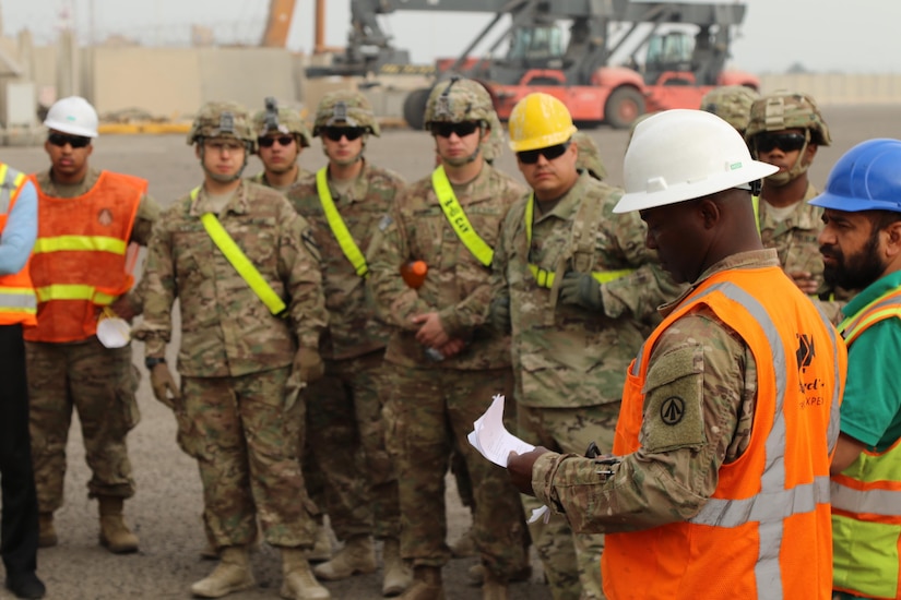 Staff Sgt. Collin Williams (right), the operations noncommissioned officer in charge for the 936th Expeditionary Terminal Operating Element and native of Brooklyn, N.Y., gives a safety brief before Soldiers and contractors begin the tedious process of unloading and reloading the large, medium speed, roll on roll off vehicle cargo ship USNS Brittin (T-AKR-305), at the Port of Shuaiba, Kuwait, March 12. Soldiers and contractors will unload approximately 700 pieces of military equipment and reload another 500 pieces.