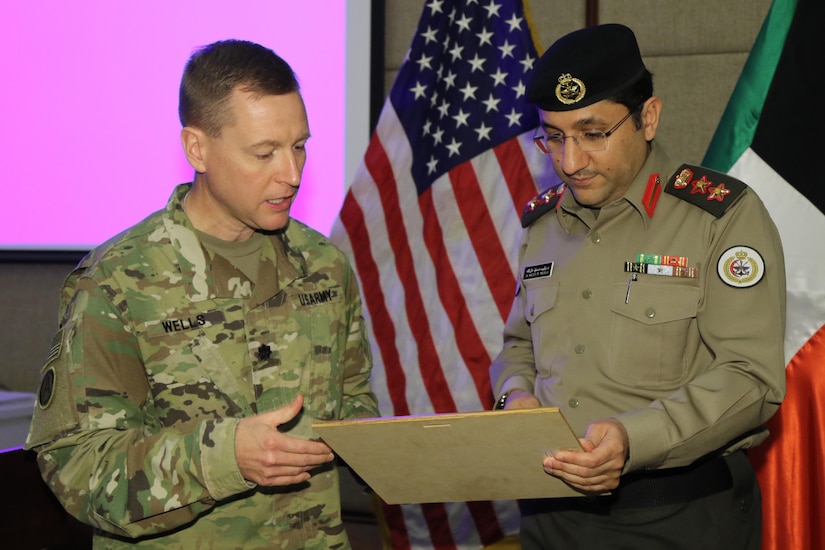 U.S. Army Lt. Col. Ron Wells, the commanding surgeon for Area Support Group- Kuwait presents Kuwait Army Col. Waleed Malalla, the director of the Kuwait Armed Forces Hospital and the acting chief of medical services, with a certificate of appreciation after a Medical Evacuation meeting hosted, for the first time, at KAFH, March 5. This meeting is one of many partnership events that U.S. Soldiers, Airmen and Kuwaiti soldiers and airmen participate in together. Practical exercises such as mass casualty events and medical evacuations are the stepping stones used to elevate the partnership.