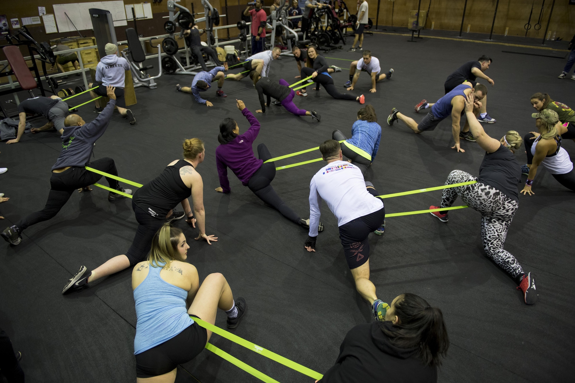 Participants perform warm up stretches during the LifeFit Tour exercise demonstration March 21, 2017, at Yokota Air Base, Japan. The goal of the event was to bring like-minded military members and their families together in a fun learning experience on fundamental exercise safety and form. (U.S. Air Force photo by Airman 1st Class Donald Hudson)