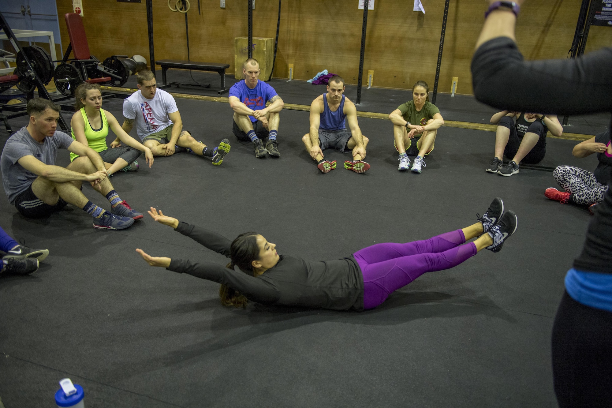 Jackie Perez, athletic coach and professional CrossFit competitor, demonstrates proper form to participants during the LifeFit Tour exercise demonstration March 21, 2017, at Yokota Air Base, Japan. Perez graduated with a Bachelors of Science in Kinesiology and continued with a career in fitness and personal training and has competed consecutively in the Reebok CrossFit Games. (U.S. Air Force photo by Airman 1st Class Donald Hudson)