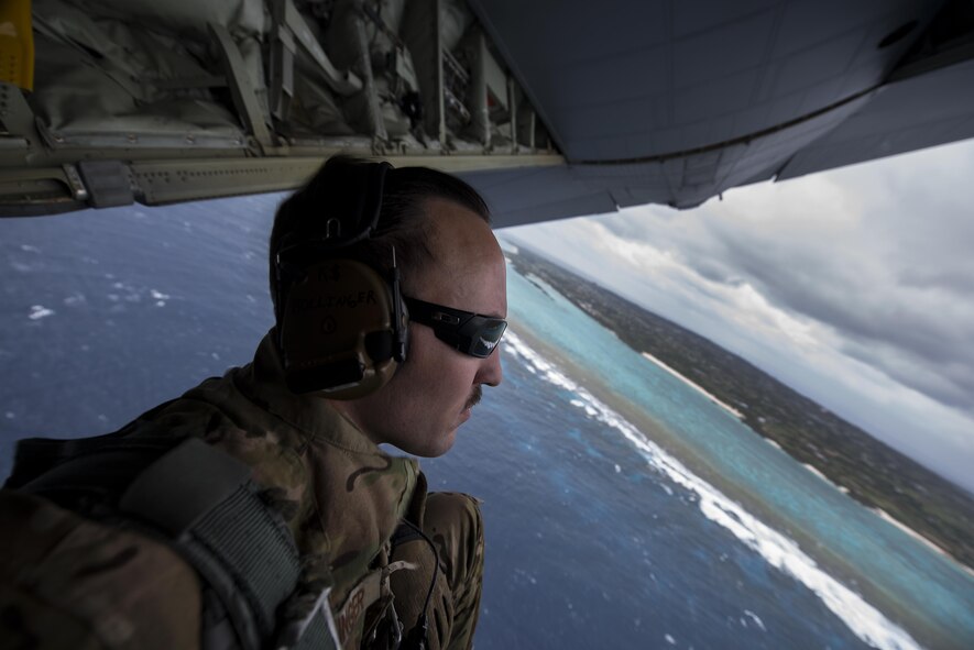 U.S. Air Force Tech. Sgt. Kade Bollinger, 17th Special Operations Squadron MC-130J Commando II instructor loadmaster, observes the horizon during a training sortie March 21, 2017, off the coast of Okinawa, Japan. Bollinger conducted low altitude flight training with Brig. Gen. Barry Cornish, 18th Wing commander, to give him a first-hand insight into the capabilities of the 17th SOS and 353rd Special Operations Group. (U.S. Air Force photo by Airman 1st Class Corey Pettis)
