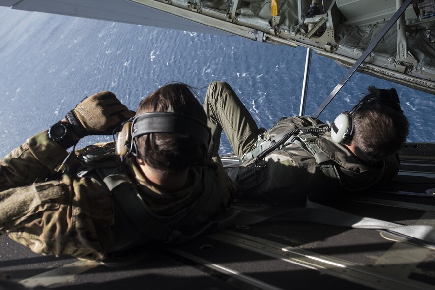 U.S. Air Force Brig. Gen. Barry Cornish, 18th Wing commander, and Tech. Sgt. Kade Bollinger, 17th Special Operations Squadron MC-130J Commando II instructor loadmaster, lay down on a cargo bay door for low altitude flight maneuvers during a training sortie March 21, 2017, off the coast of Okinawa, Japan. Cornish flew with Bollinger and other 17th SOS Airmen to experience first-hand the combat capabilities of the MC-130J and its aircrew. (U.S. Air Force photo by Airman 1st Class Corey Pettis)