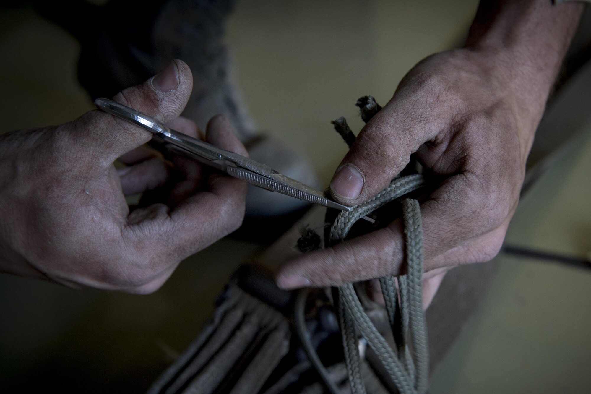 An Airman from the 374th Logistics Readiness Squadron prepares cords for rigging a bundle for a C-130J Super Hercules cargo drop exercise March 20, 2017, at Yokota Air Base, Japan. From packing the parachutes to recovering them after the drop exercises are complete, the 374 LRS is responsible for every step in building the cargo pallets to ensure the supplies land safely on the ground. (U.S. Air Force photo by Airman 1st Class Donald Hudson)