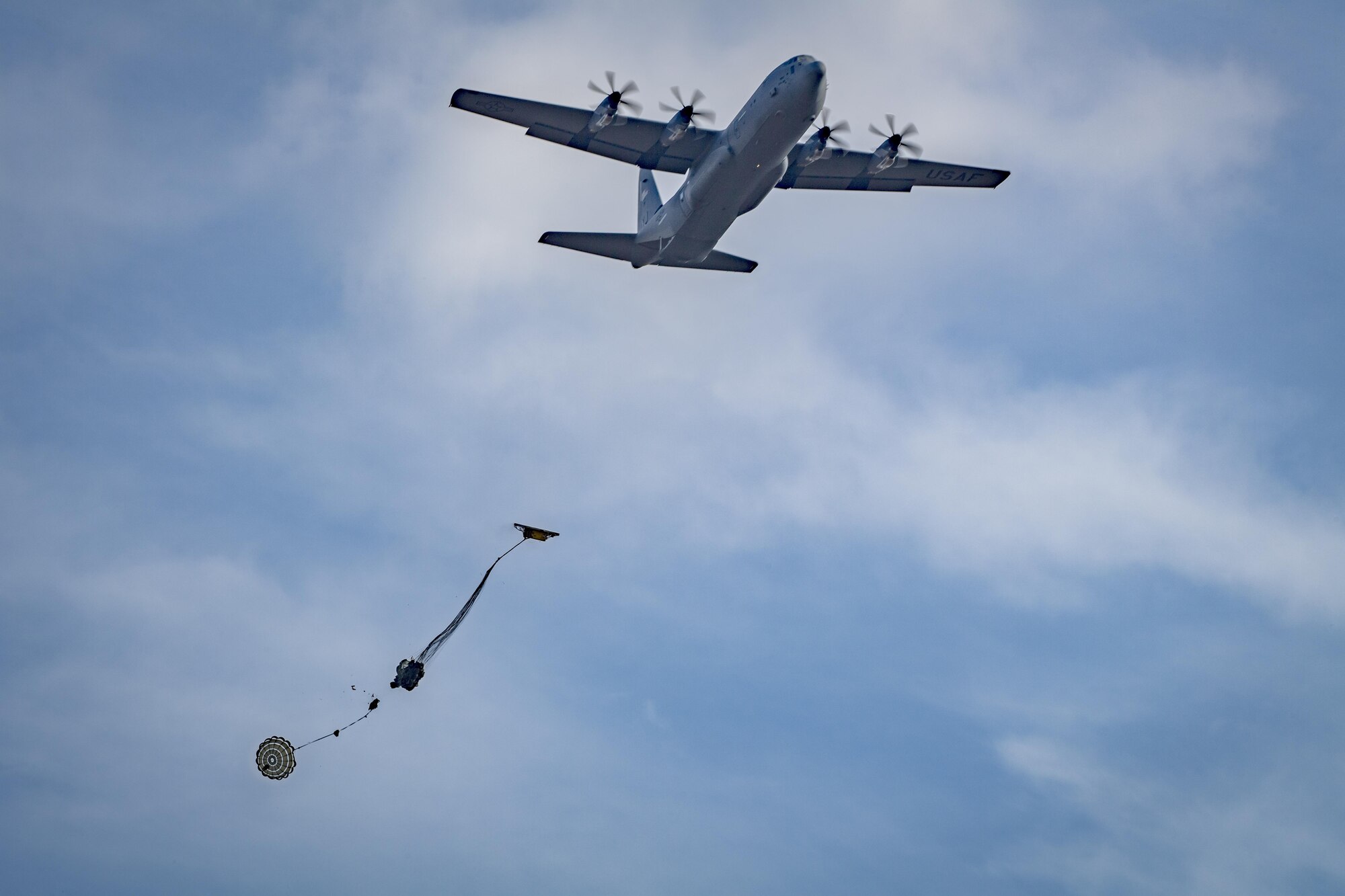 A C-130J Super Hercules drops heavy cargo during a training exercise March 22, 2017, at Camp Fuji, Japan. The exercise marked the first cargo drop for Yokota’s new C-130J Super Hercules. (U.S. Air Force photo by Airman 1st Class Donald Hudson)