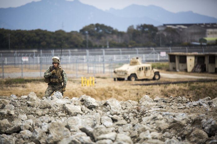U.S. Marine Corps Gunnery Sgt. Ysac Perez, the air base ground defense staff non-commissioned officer in charge for Marine Wing Support Squadron (MWSS) 171, observes how Marines deal with the set objectives during exercise Tanuki Wrath on Marine Corps Air Station Iwakuni, Japan, March 22, 2017. MWSS-171 conducted the exercise to help train Marines to set up security around a downed aircraft and how to control a riot. (U.S. Marine Corps photo by Lance Cpl. Jacob A. Farbo)
