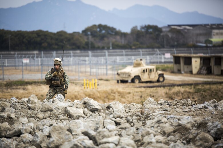 U.S. Marine Corps Gunnery Sgt. Ysac Perez, the air base ground defense staff non-commissioned officer in charge for Marine Wing Support Squadron (MWSS) 171, observes how Marines deal with the set objectives during exercise Tanuki Wrath on Marine Corps Air Station Iwakuni, Japan, March 22, 2017. MWSS-171 conducted the exercise to help train Marines to set up security around a downed aircraft and how to control a riot. (U.S. Marine Corps photo by Lance Cpl. Jacob A. Farbo)