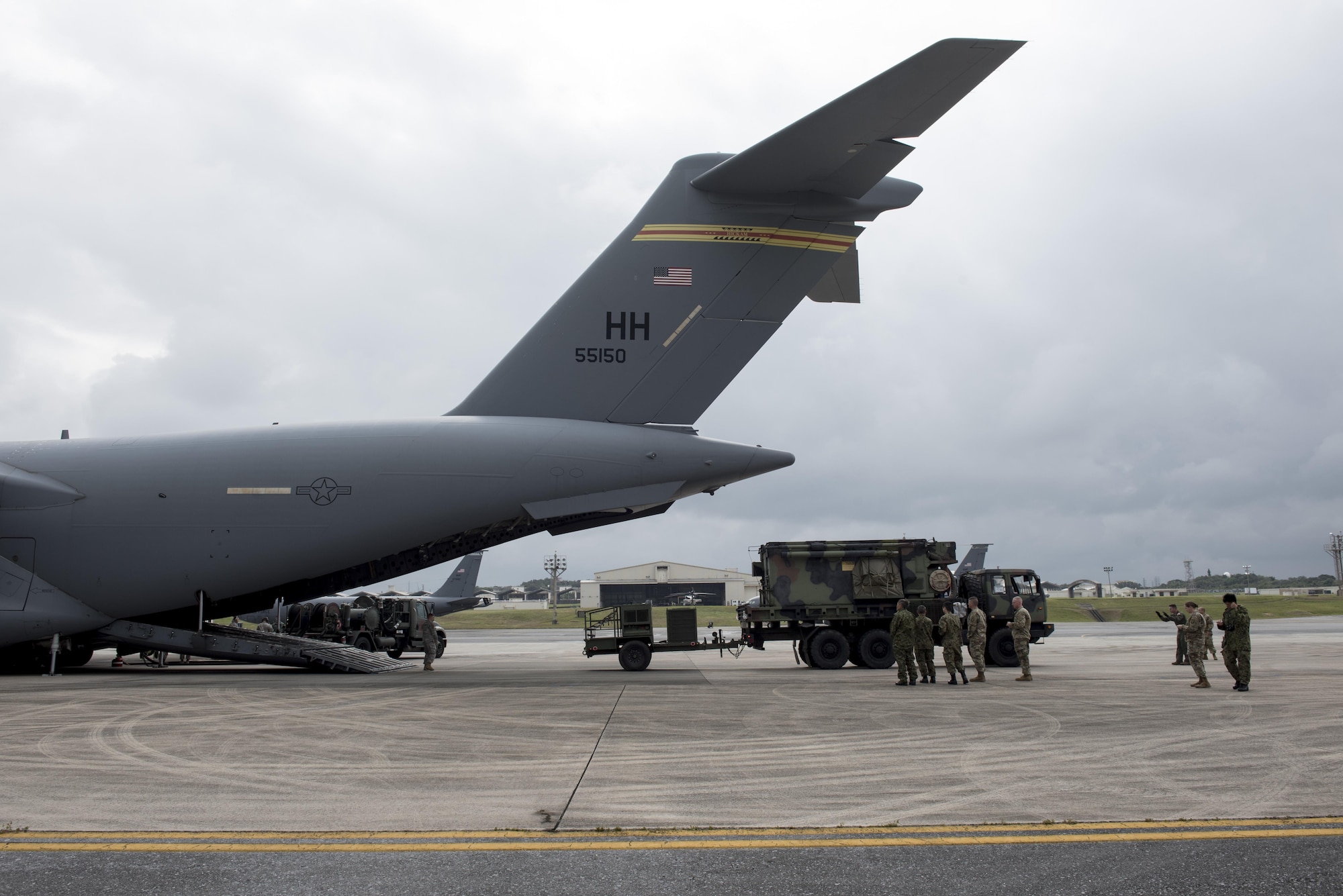 Japan Ground Self-Defense Force members observe Soldiers of the 1st Battalion, 1st Air Defense Artillery Regiment load Patriot missile battery equipment onto a C-17 Globe Master III March 14, 2017, on Kadena Air Base, Japan. The Patriot missile system is a long-range air defense asset and can be broken down to be transported via plane anywhere in the world in a matter of hours. (U.S. Air Force photo by Senior Airman Omari Bernard)