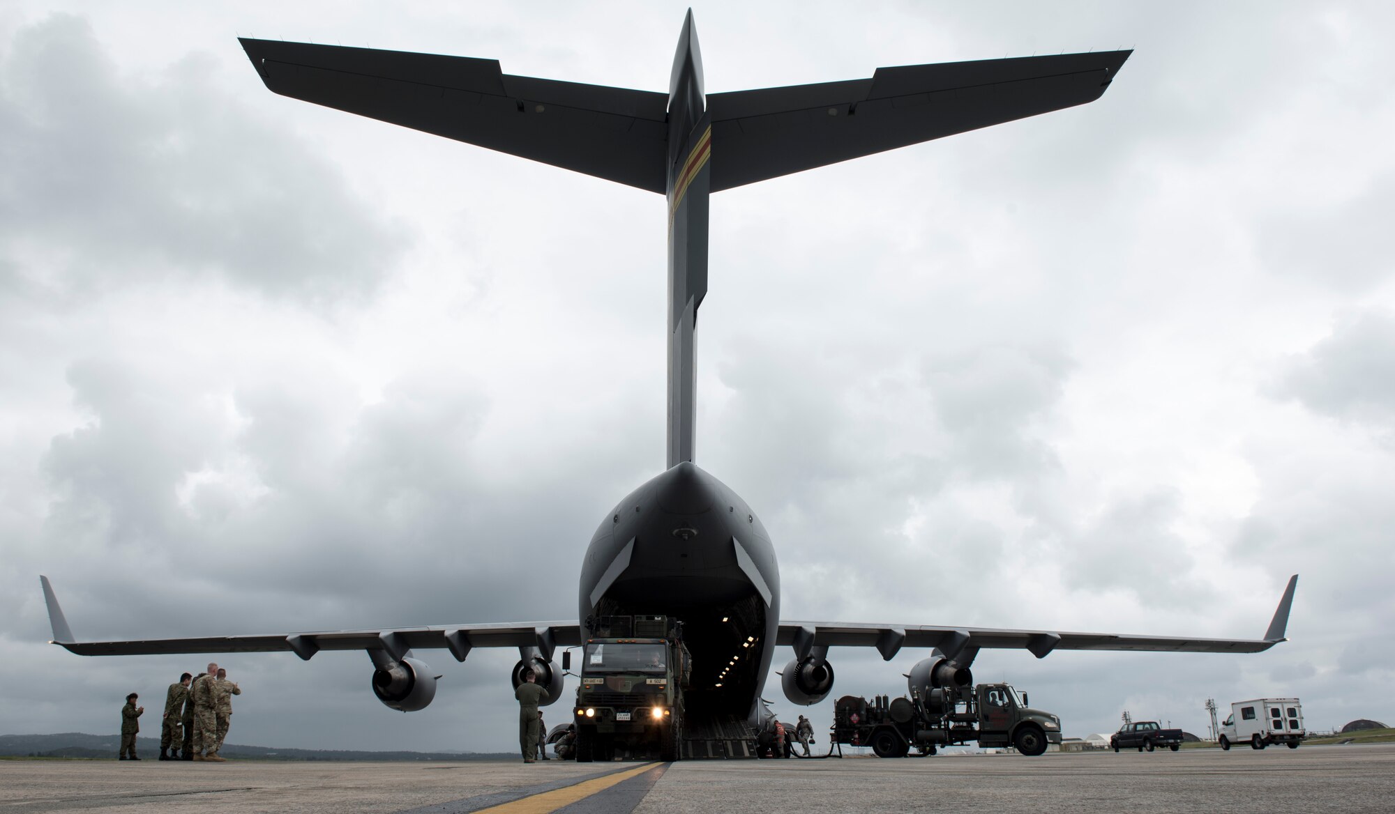 Japan Ground Self Defense Force members observe Soldiers of the 1st Battalion, 1st Air Defense Artillery Regiment load a Patriot missile battery onto a C-17 Globe Master III March 14, 2017, on Kadena Air Base, Japan. The C-17 Globe Master III is capable of carrying payloads up to 169,000 pounds (76,657 kilograms). (U.S. Air Force photo by Senior Airman Omari Bernard)