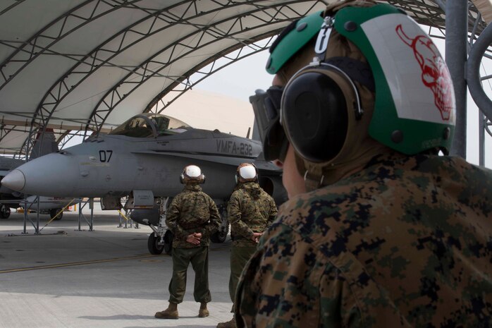 U.S. Marines with Marine Attack Squadron (VMFA) 232 wait for the pilot of an F/A-18C Hornet aircraft to prepare for takeoff at Marine Corps Air Station (MCAS) Iwakuni, Japan, March 22, 2017. The squadron left MCAS Miramar, Calif., March 11, 2017, and arrived at MCAS Iwakuni March 15. The squadron is part of the Unit Deployment Program and helps provide air support to III Marine Expeditionary Force through training and combat operations. (U.S. Marine Corps photo by Lance Cpl. Gabriela Garcia-Herrera)