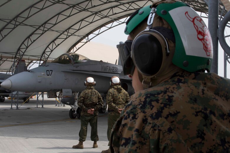 U.S. Marines with Marine Attack Squadron (VMFA) 232 wait for the pilot of an F/A-18C Hornet aircraft to prepare for takeoff at Marine Corps Air Station (MCAS) Iwakuni, Japan, March 22, 2017. The squadron left MCAS Miramar, Calif., March 11, 2017, and arrived at MCAS Iwakuni March 15. The squadron is part of the Unit Deployment Program and helps provide air support to III Marine Expeditionary Force through training and combat operations. (U.S. Marine Corps photo by Lance Cpl. Gabriela Garcia-Herrera)