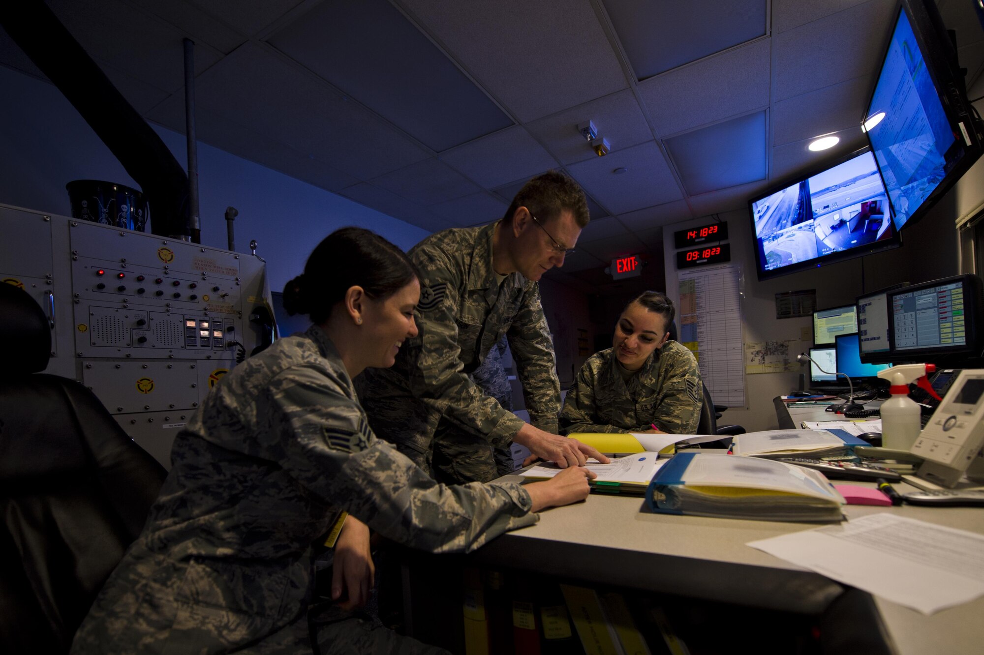 Tech Sgt. Derwin Wilson, 434th Air Refueling Wing command post controller, reviews flight following procedures with Senior Airman Alexis O'Connell, 914th Air Lift Wing command post reports manager, and Tech Sgt. Kristina Burke, 914th ALW command post training manager at Grissom Air Reserve Base, Ind., March 2, 2017. O'Connell and Burke visited Grissom and trained in the command post as part of the 914th ALW's conversion to a KC-135R Statrotanker unit.