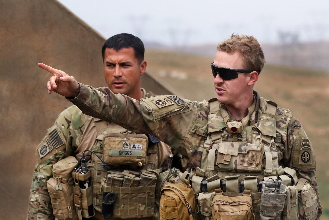 Army Sgt. 1st Class Daniel Byerly, right, and Staff Sgt. Kimo Griggs conduct a sergeant-of-the-guard handover at a tactical assembly area during a mission supporting the Iraqi army's 9th Division near Al Tarab, Iraq, March 18, 2017. Army photo by Staff Sgt. Jason Hull